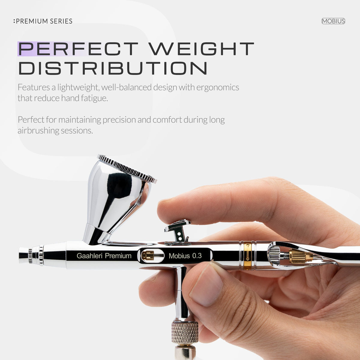 Mobius 0.3mm airbrush held in the hand
